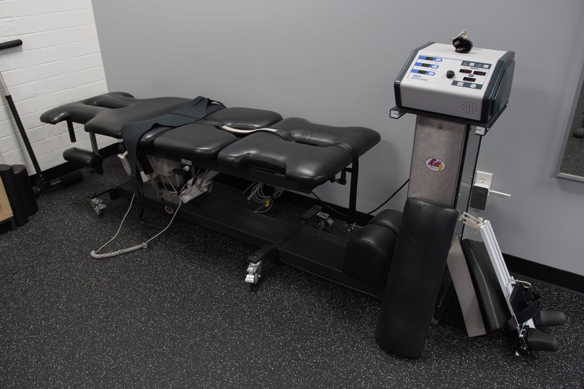 Spinal decompression table with its harness and the control console beside it