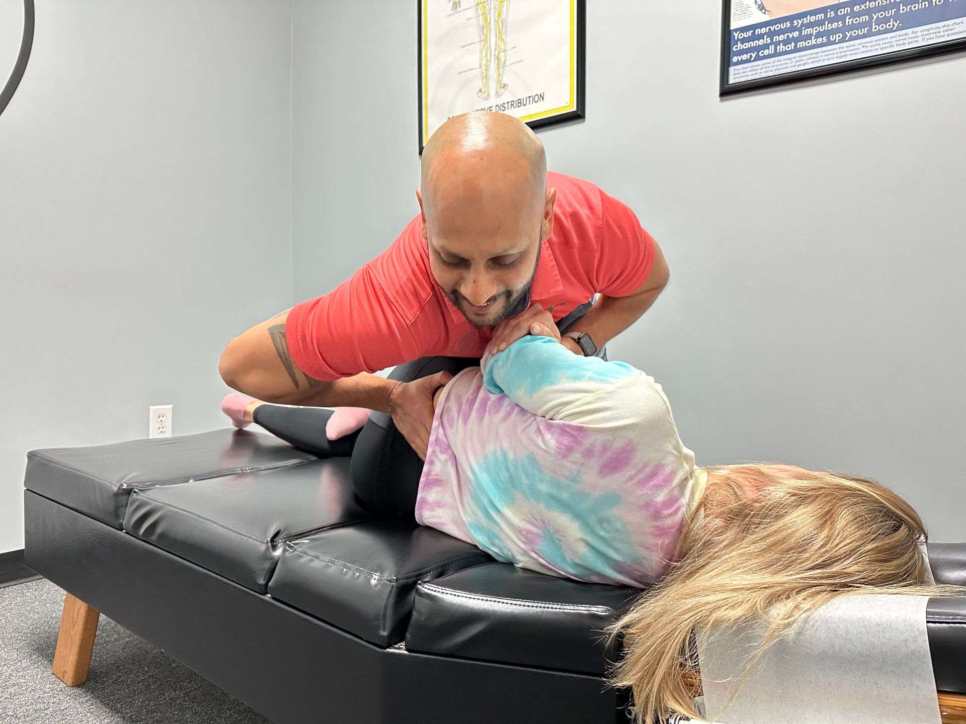 Chiropractor performing a side-posture adjustment at Breakaway Chiropractic in Frisco, TX