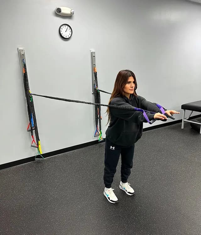 Patient working with resistance bands in the rehab area at Breakaway Chiropractic in Frisco, TX