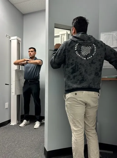 Patient being positioned for a digital spinal X-ray at Breakaway Chiropractic in Frisco, TX